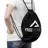 a woman carrying a gym bag with a freefittings logo on it